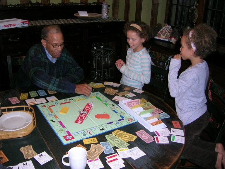 My grandpa, Stuart, schooling Lili and I at Monopoly