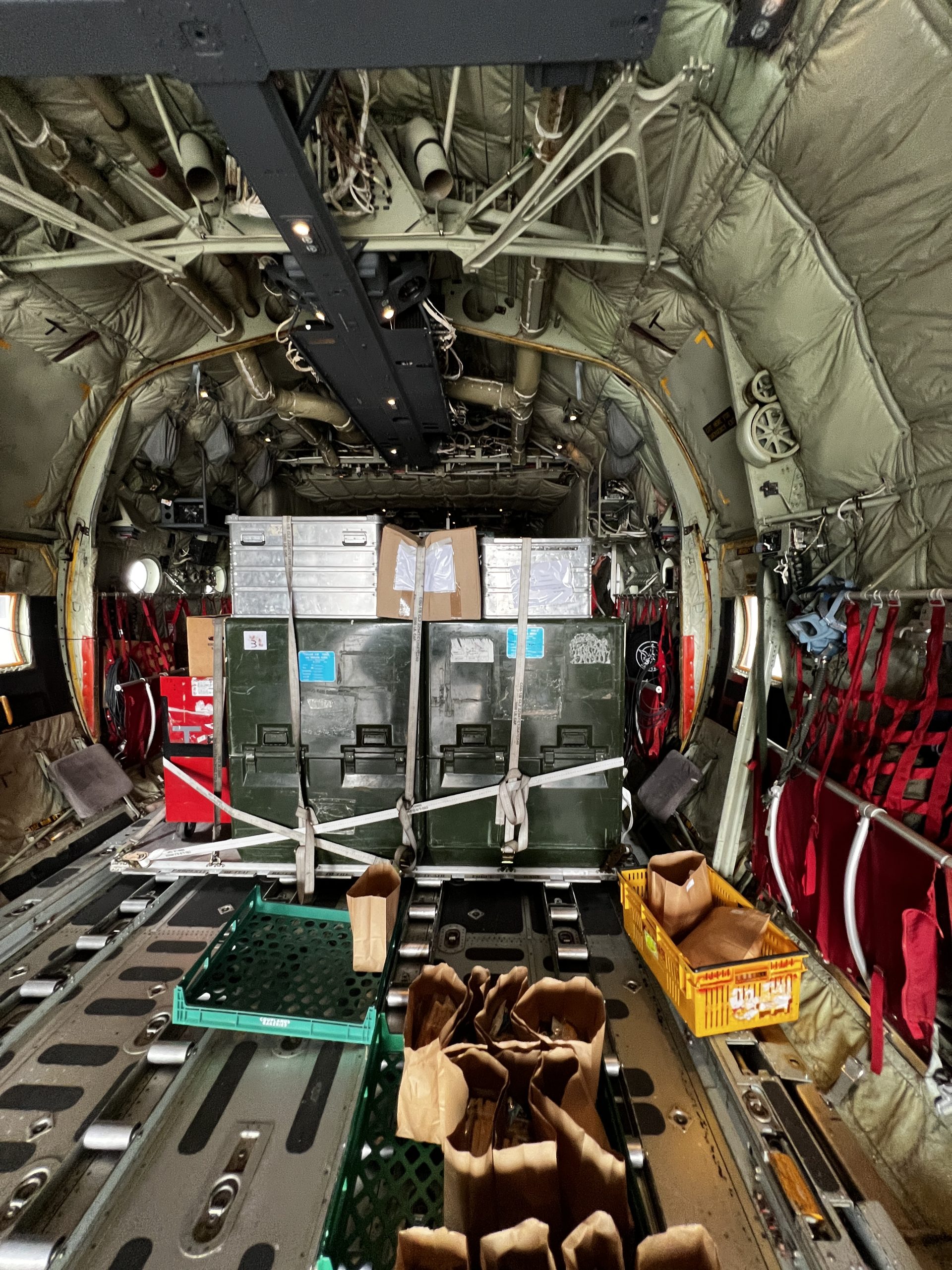 Squeezing past cargo to board the plane