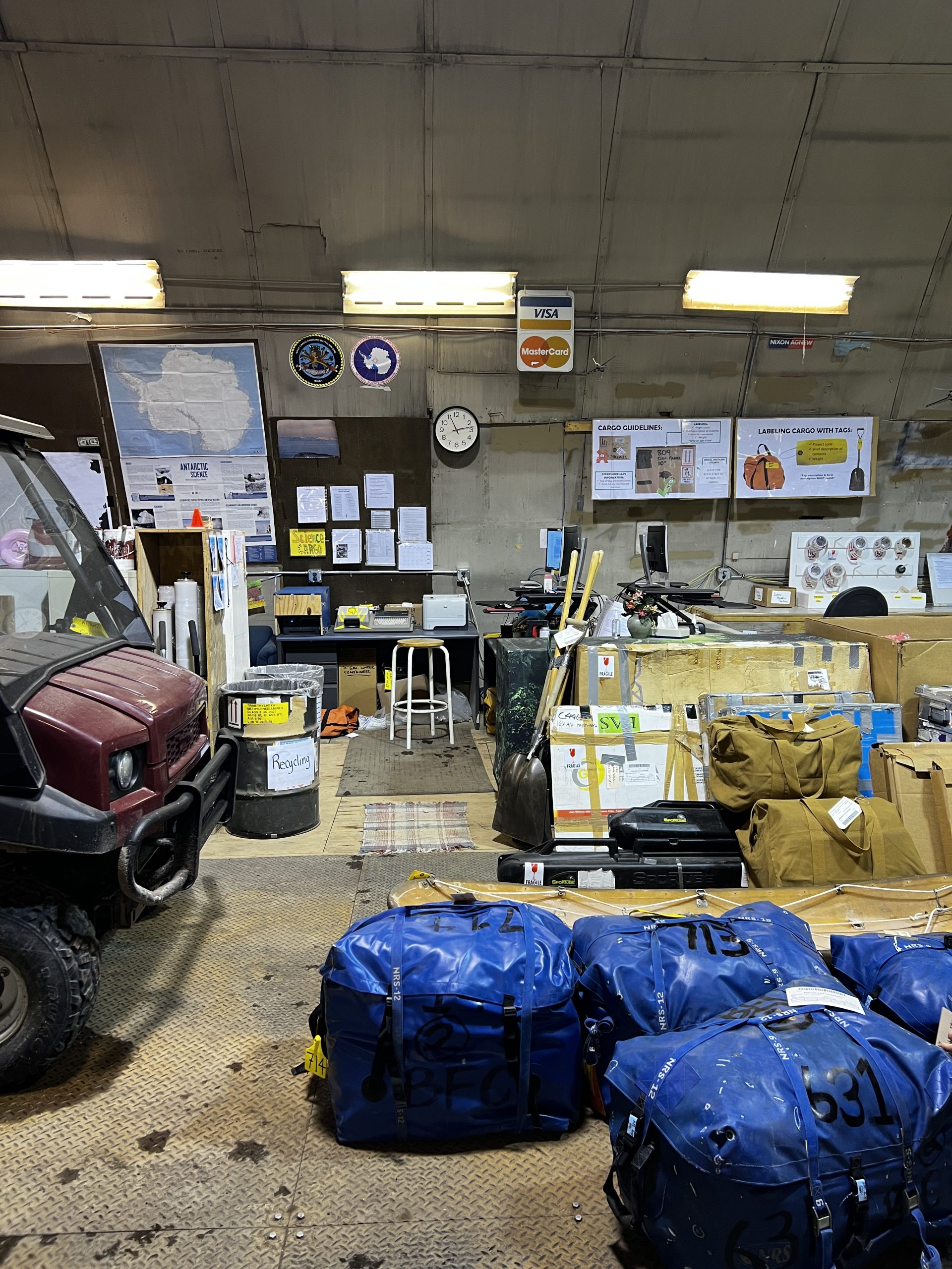 More of our cargo piled up in the warehouse (including our blue survival bags)