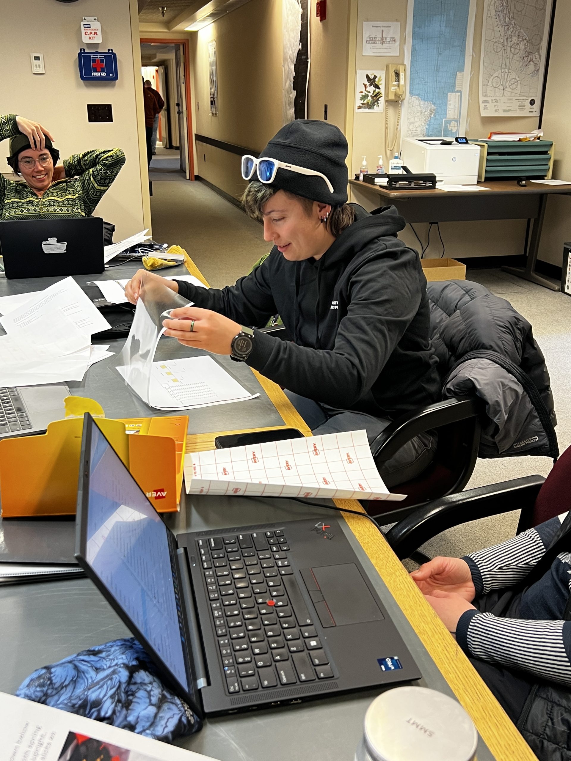 Ilyse trying to laminate 20+ papers by hand