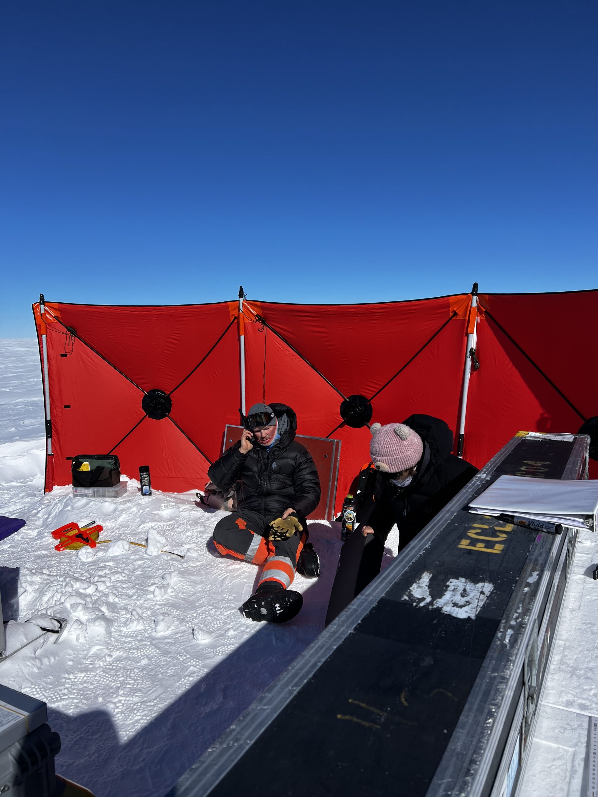 Zoe and Elliot basking in the sun protected by the wind wall
