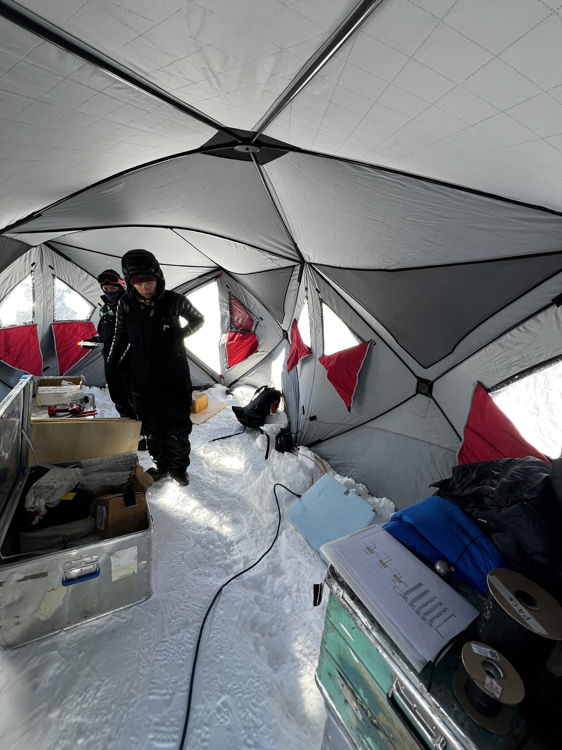 Dylen and Ilyse working in their tent