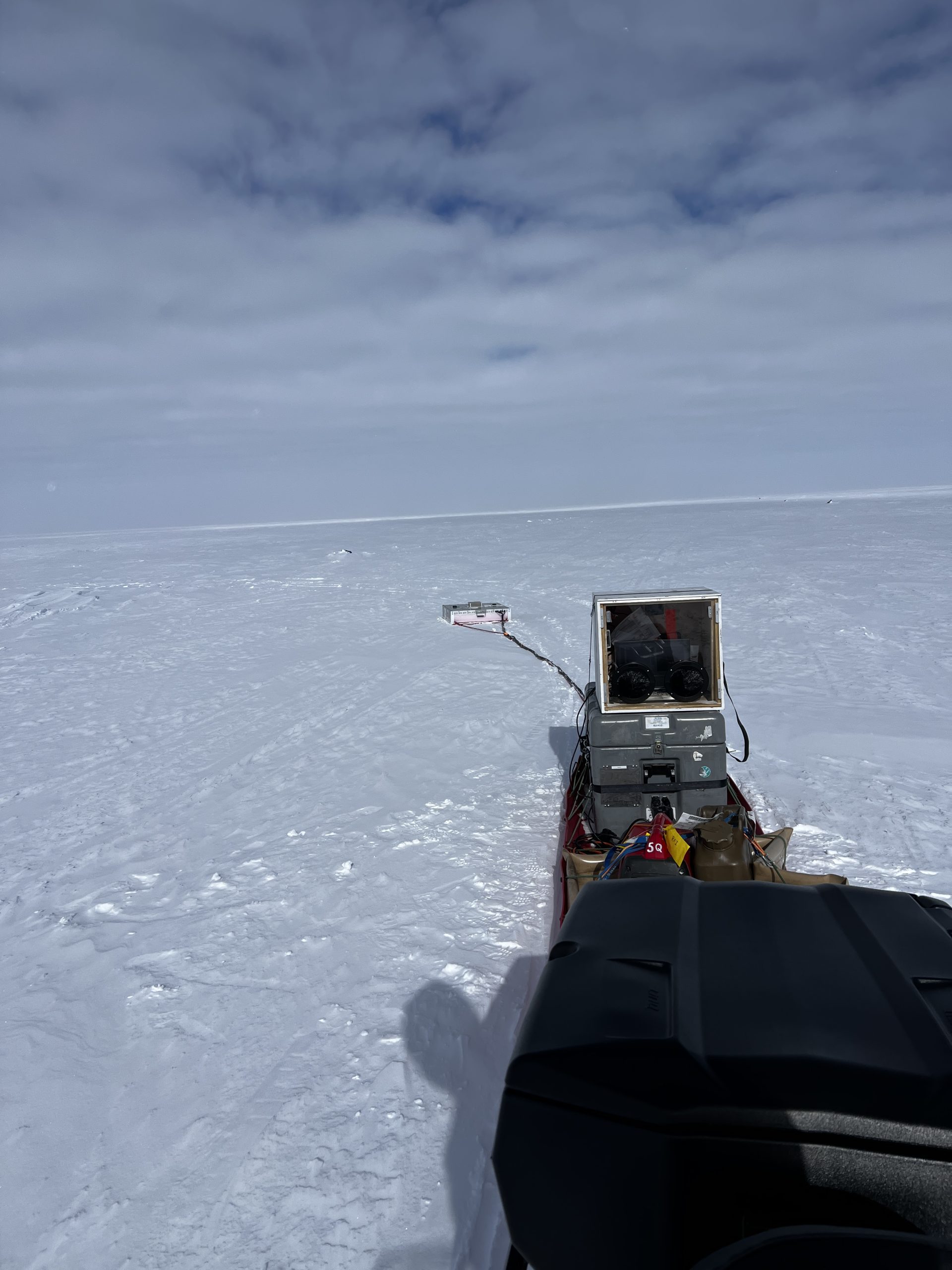 The EAGER computer (big gray box) and antenna (pink sled in the distance) being towed behind my Ski-Doo