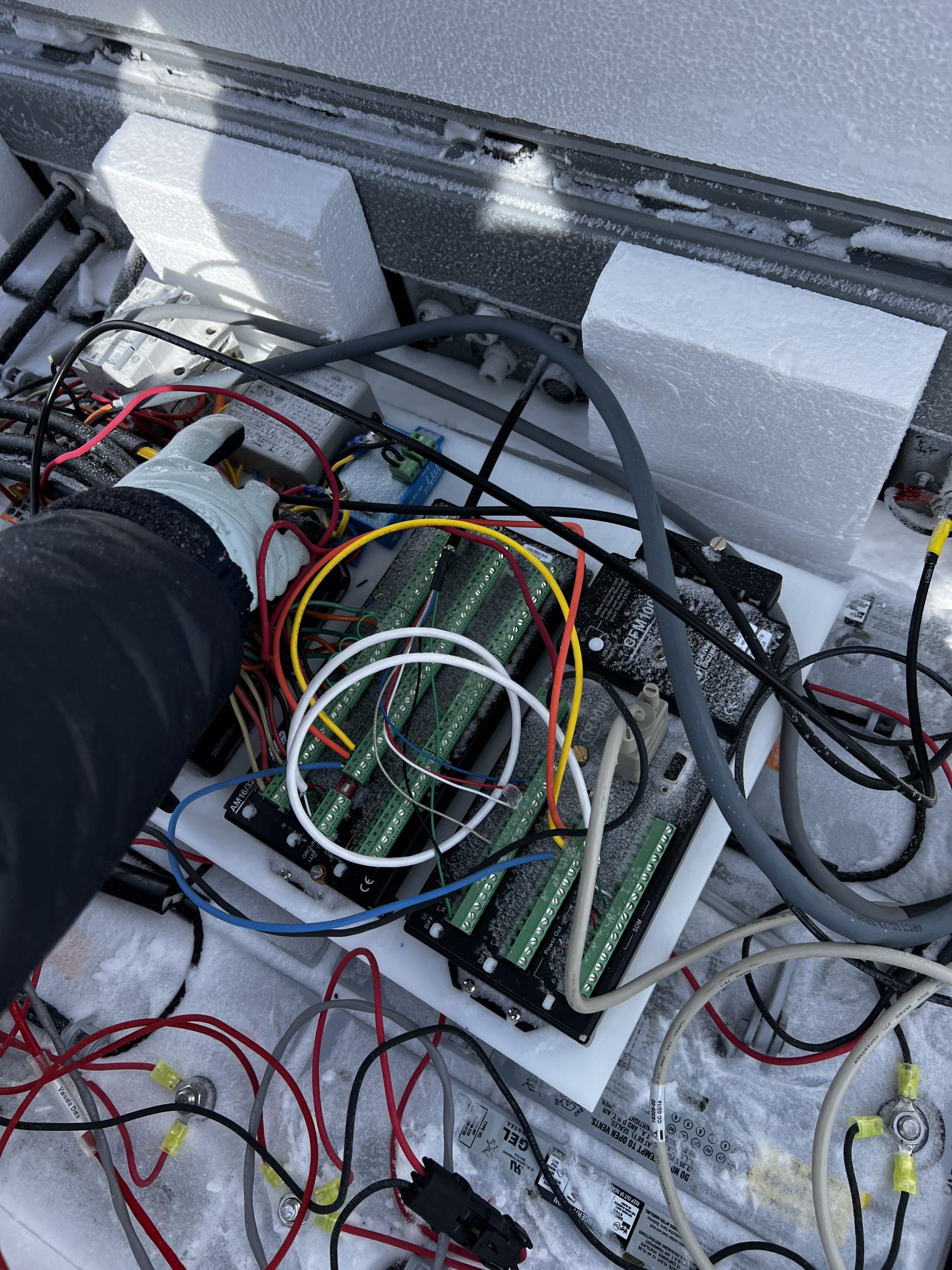 Ellen's little hand messing with wires in the battery box