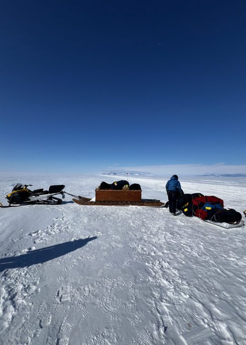 Attaching sleds to the Ski-Doo to drive to the I-Hut